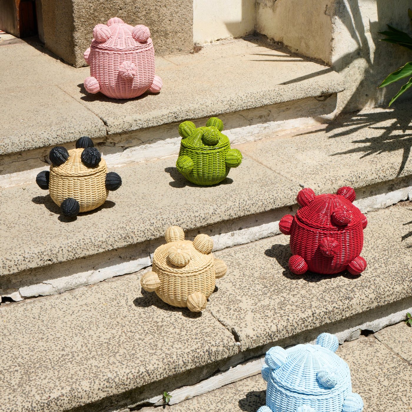 Osito jars in different colors on stone steps